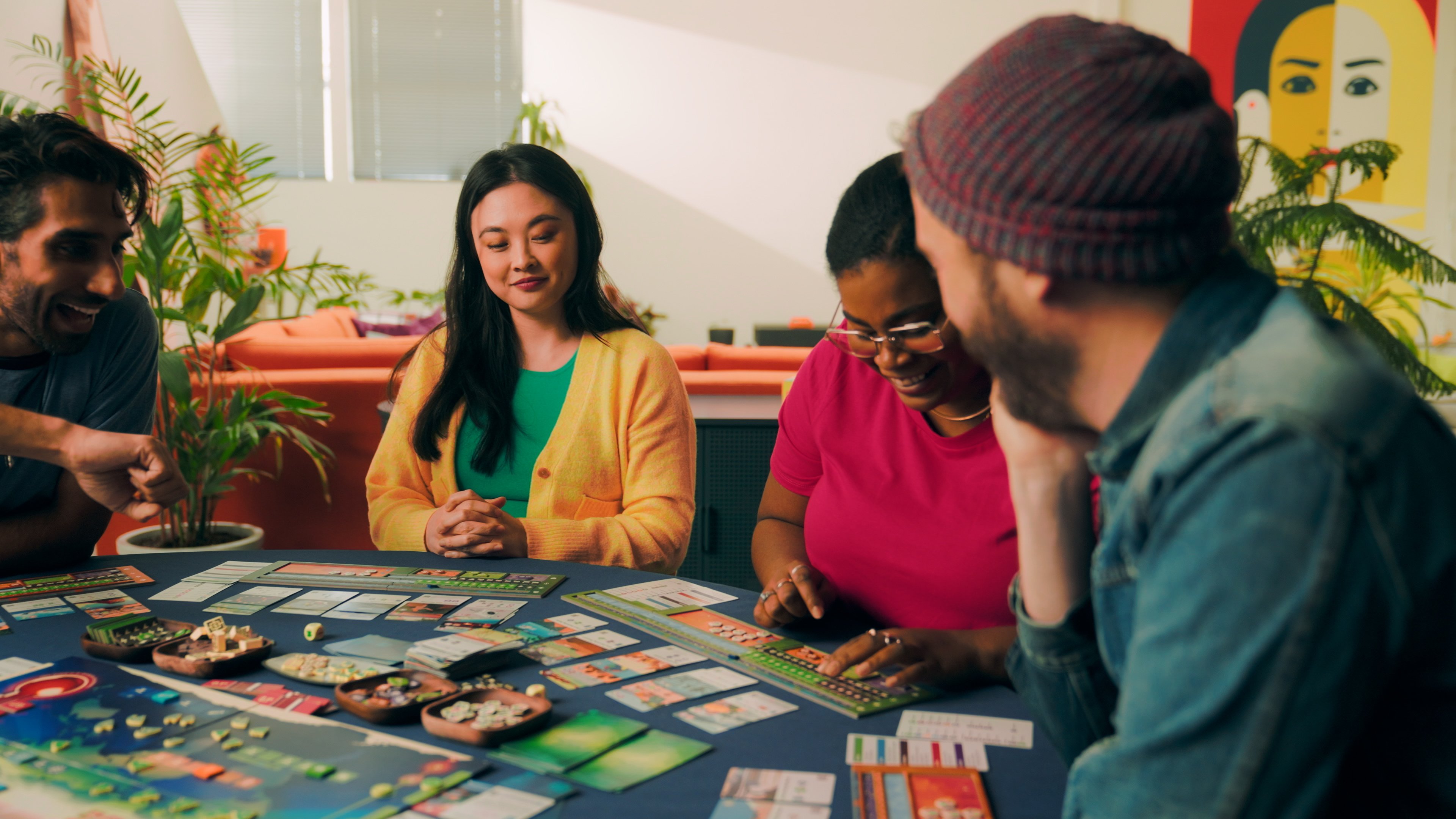 Diverse group play Daybreak board game